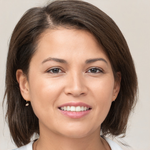 Joyful white young-adult female with medium  brown hair and brown eyes