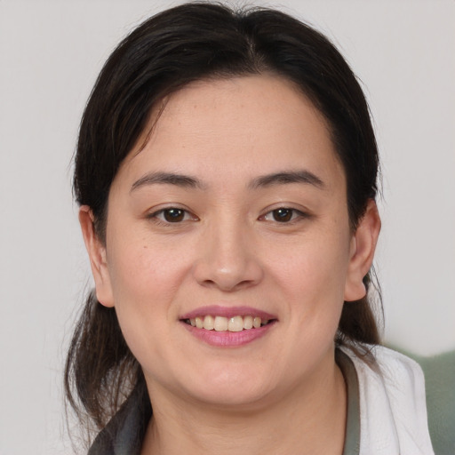 Joyful white young-adult female with medium  brown hair and brown eyes