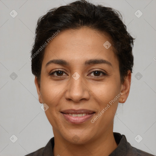 Joyful latino adult female with short  brown hair and brown eyes