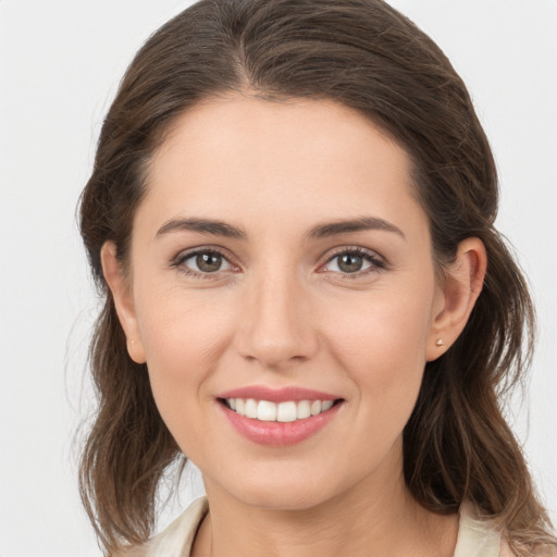 Joyful white young-adult female with medium  brown hair and brown eyes