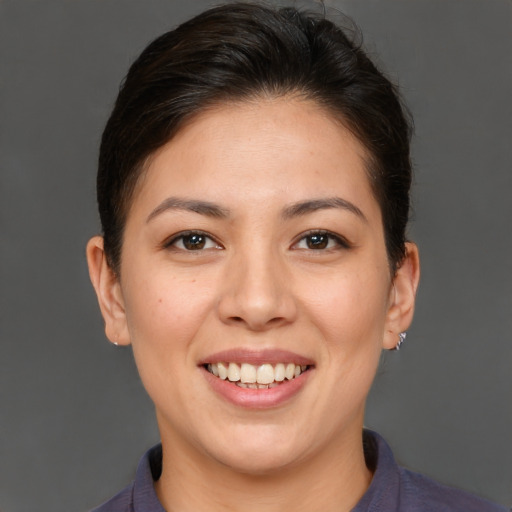 Joyful asian young-adult female with short  brown hair and brown eyes