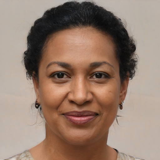 Joyful black adult female with short  brown hair and brown eyes