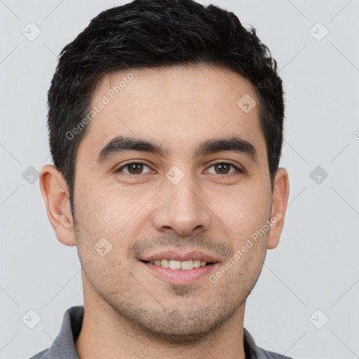 Joyful white young-adult male with short  black hair and brown eyes