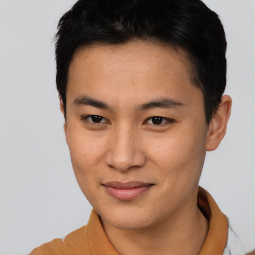 Joyful asian young-adult male with short  brown hair and brown eyes