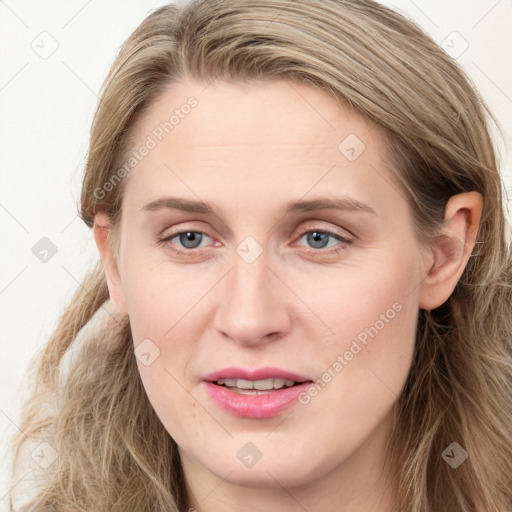 Joyful white young-adult female with long  brown hair and blue eyes