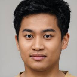 Joyful asian young-adult male with short  black hair and brown eyes