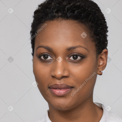 Joyful black young-adult female with short  black hair and brown eyes