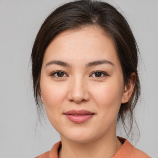Joyful white young-adult female with medium  brown hair and brown eyes