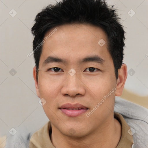 Joyful asian young-adult male with short  black hair and brown eyes