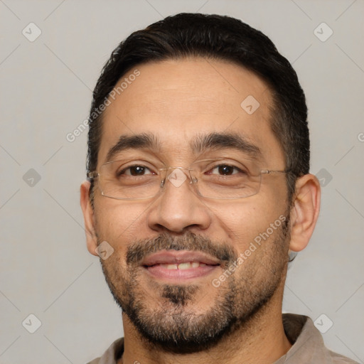 Joyful white adult male with short  black hair and brown eyes