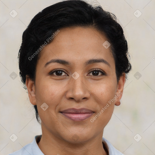 Joyful latino adult female with short  brown hair and brown eyes