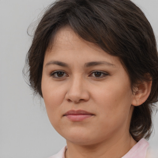 Joyful white young-adult female with medium  brown hair and brown eyes