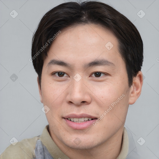 Joyful asian young-adult male with short  brown hair and brown eyes