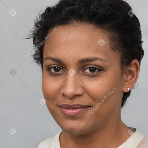 Joyful black young-adult female with short  brown hair and brown eyes