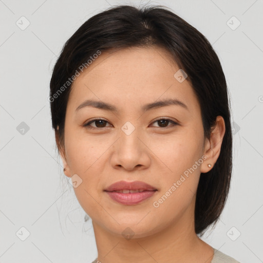 Joyful asian young-adult female with medium  brown hair and brown eyes