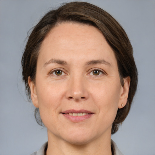 Joyful white adult female with medium  brown hair and brown eyes