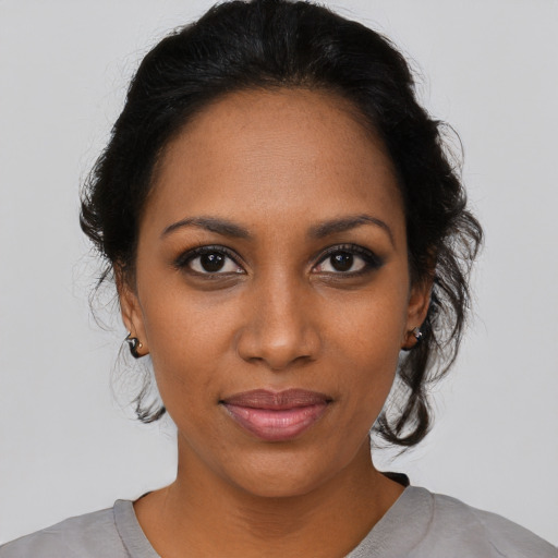 Joyful black young-adult female with medium  black hair and brown eyes