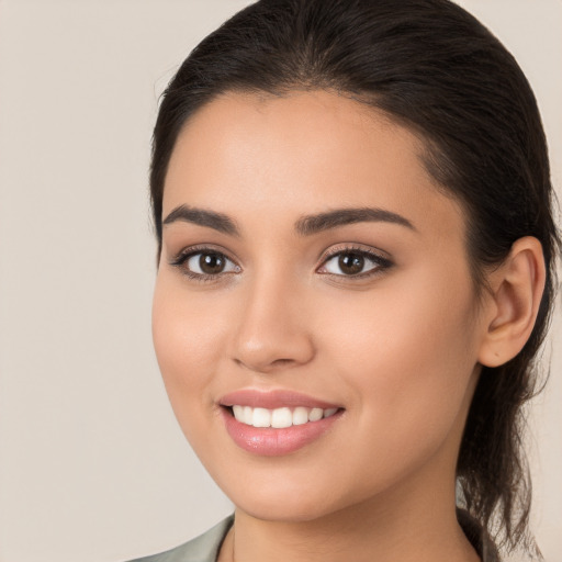 Joyful white young-adult female with long  brown hair and brown eyes