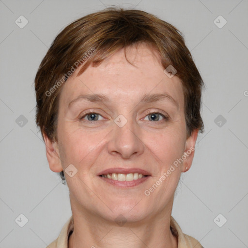 Joyful white adult female with medium  brown hair and grey eyes