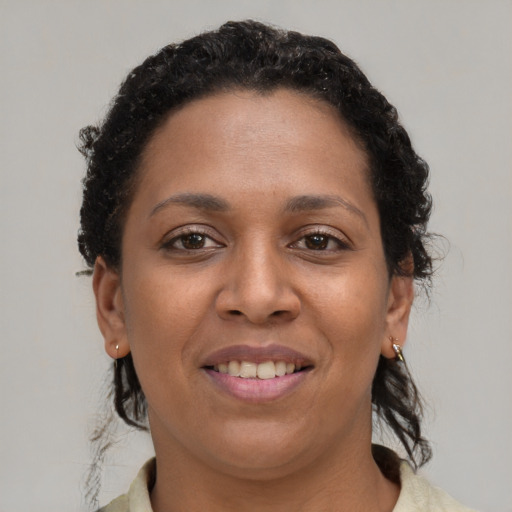 Joyful black young-adult female with short  brown hair and brown eyes