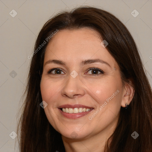 Joyful white adult female with long  brown hair and brown eyes