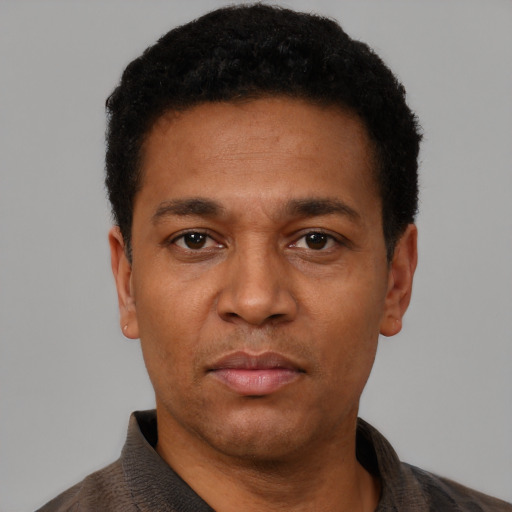 Neutral latino adult male with short  black hair and brown eyes