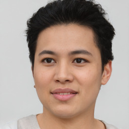 Joyful asian young-adult male with short  brown hair and brown eyes