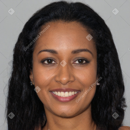 Joyful black young-adult female with long  black hair and brown eyes