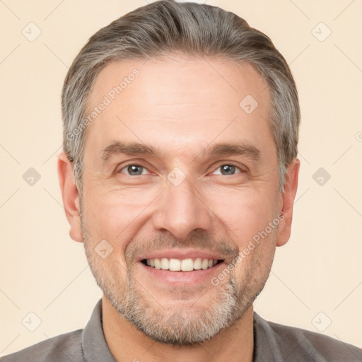 Joyful white adult male with short  brown hair and brown eyes