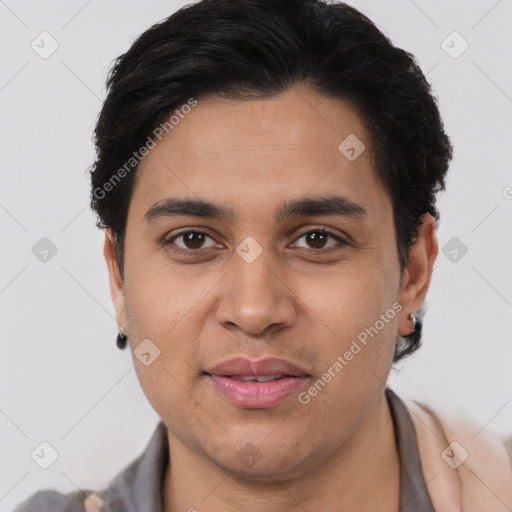 Joyful latino young-adult male with short  black hair and brown eyes