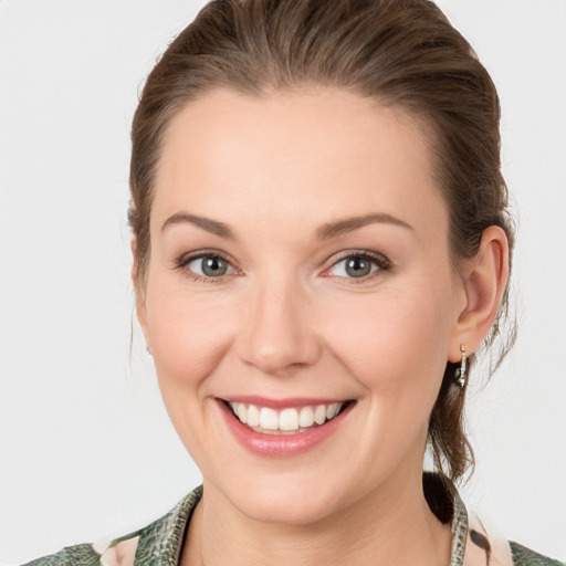 Joyful white young-adult female with medium  brown hair and blue eyes