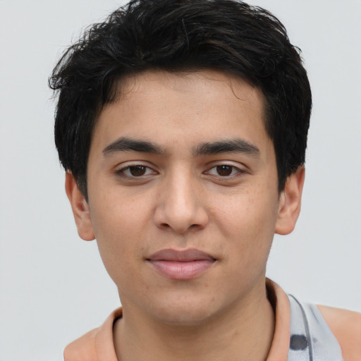 Joyful white young-adult male with short  black hair and brown eyes