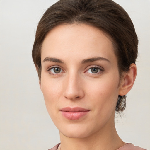 Joyful white young-adult female with short  brown hair and grey eyes