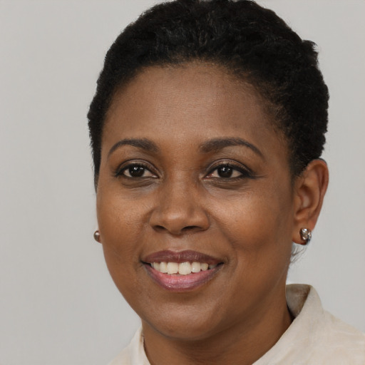 Joyful black young-adult female with short  brown hair and brown eyes