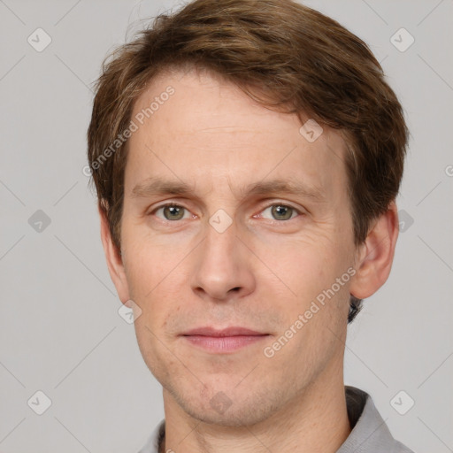 Joyful white adult male with short  brown hair and grey eyes