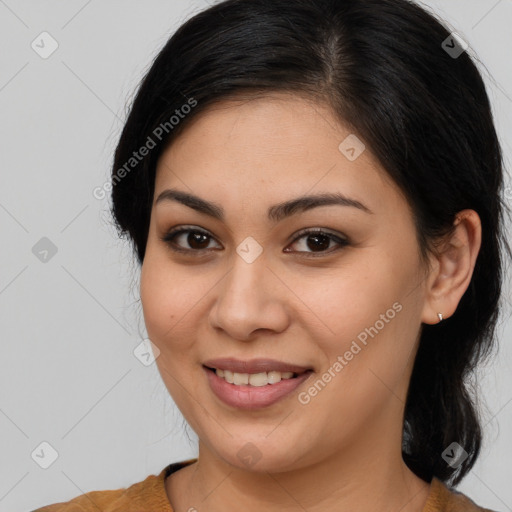 Joyful latino young-adult female with medium  brown hair and brown eyes