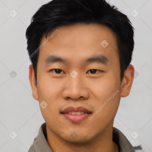 Joyful asian young-adult male with short  black hair and brown eyes