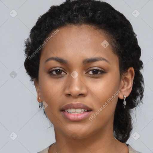 Joyful black young-adult female with long  black hair and brown eyes