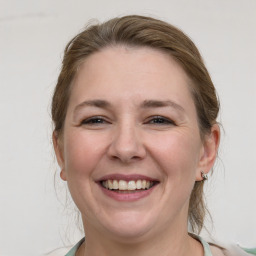 Joyful white young-adult female with medium  brown hair and grey eyes