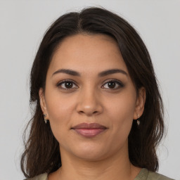 Joyful latino young-adult female with medium  brown hair and brown eyes