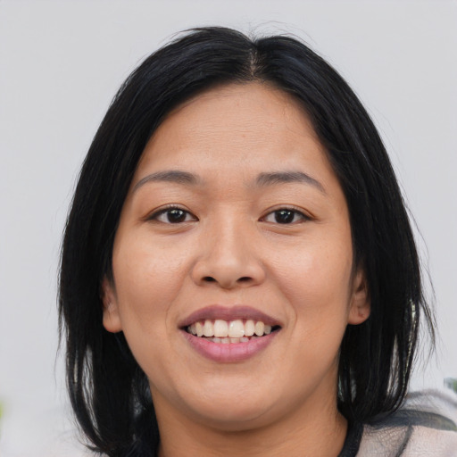 Joyful asian young-adult female with medium  black hair and brown eyes