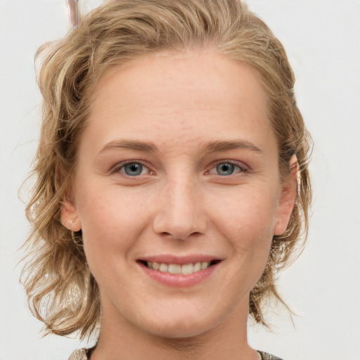 Joyful white young-adult female with medium  brown hair and blue eyes