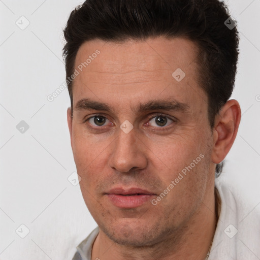 Joyful white adult male with short  brown hair and brown eyes