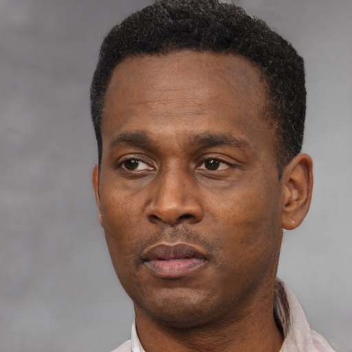 Neutral black adult male with short  black hair and brown eyes