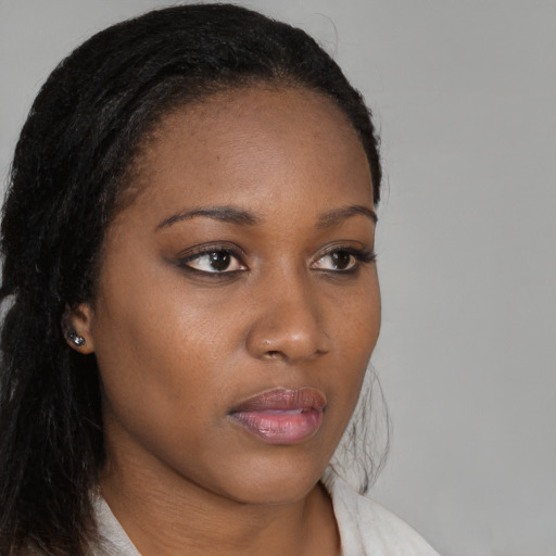 Neutral black young-adult female with long  brown hair and brown eyes