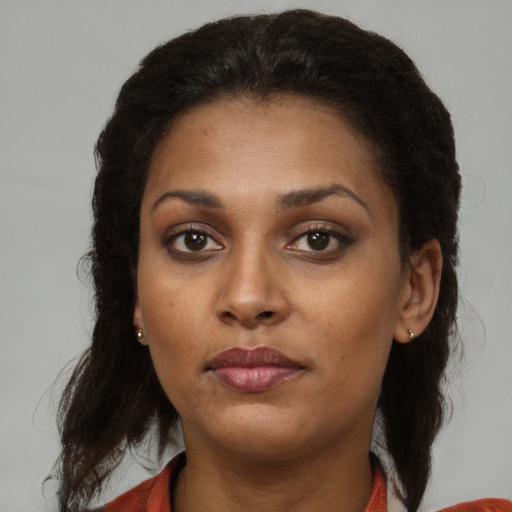 Neutral black young-adult female with medium  brown hair and brown eyes