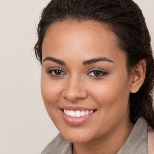 Joyful white young-adult female with long  brown hair and brown eyes