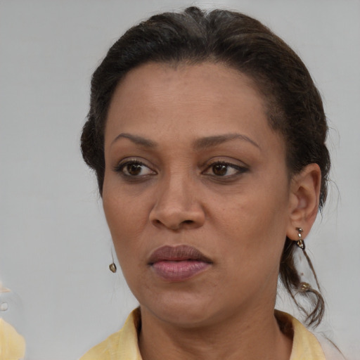 Joyful white adult female with medium  brown hair and brown eyes