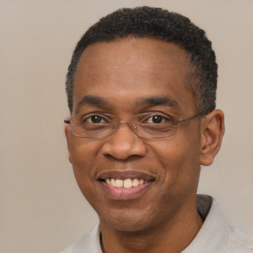 Joyful black adult male with short  black hair and brown eyes