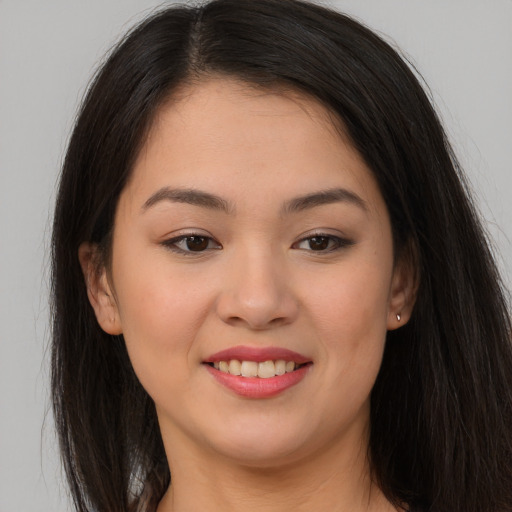 Joyful asian young-adult female with long  brown hair and brown eyes